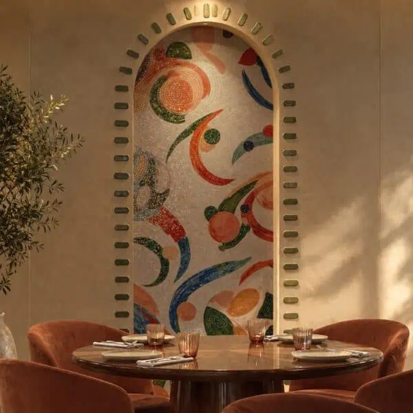 Abstract Floral Arch Mosaic Panel An abstract floral arch mosaic in coral, green and blue tesserae set inside a curved wall niche.