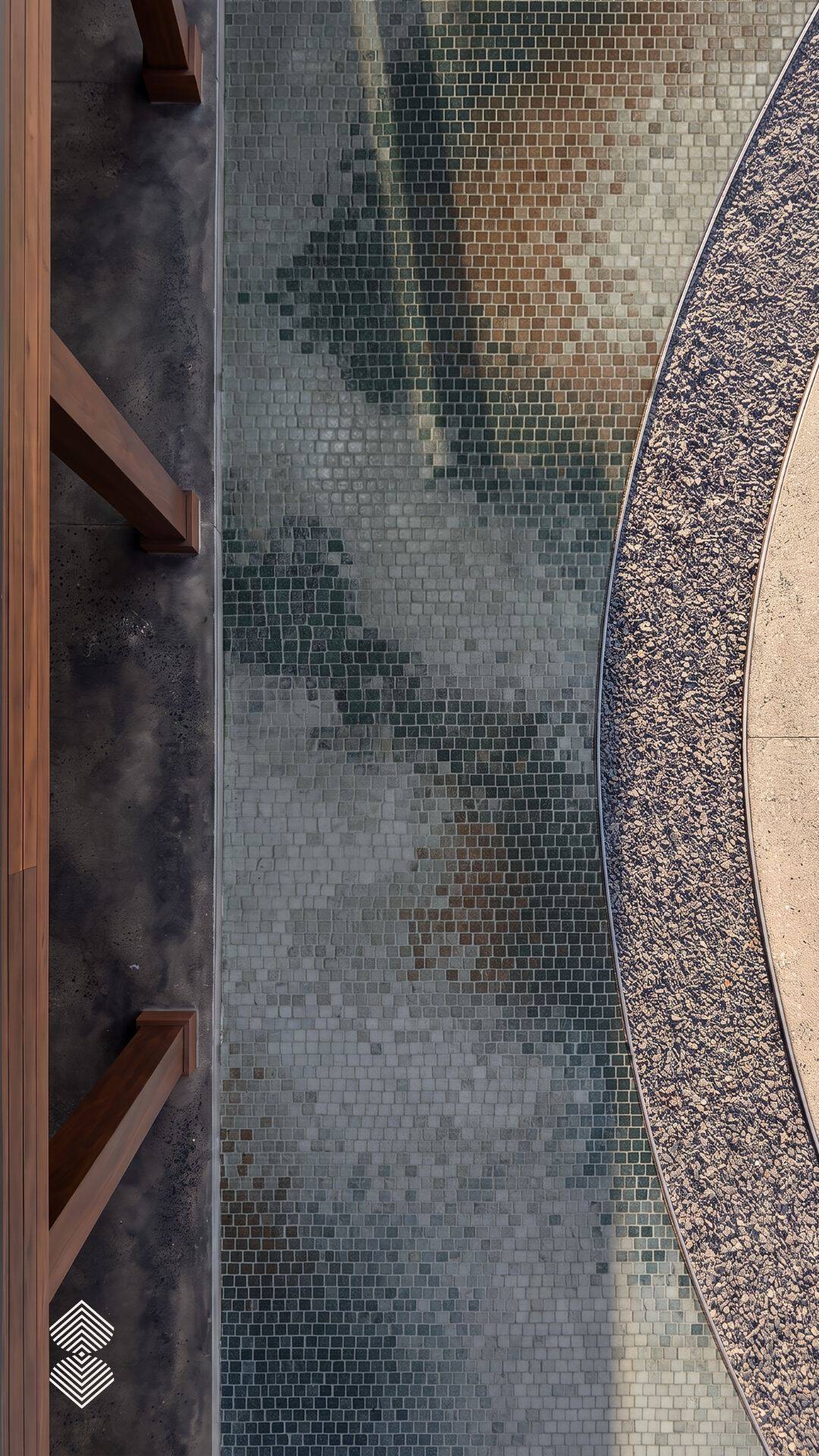 Overhead view of a mosaic walkway tile path with a soft gray-green shadow pattern bordered by curved gravel edging.