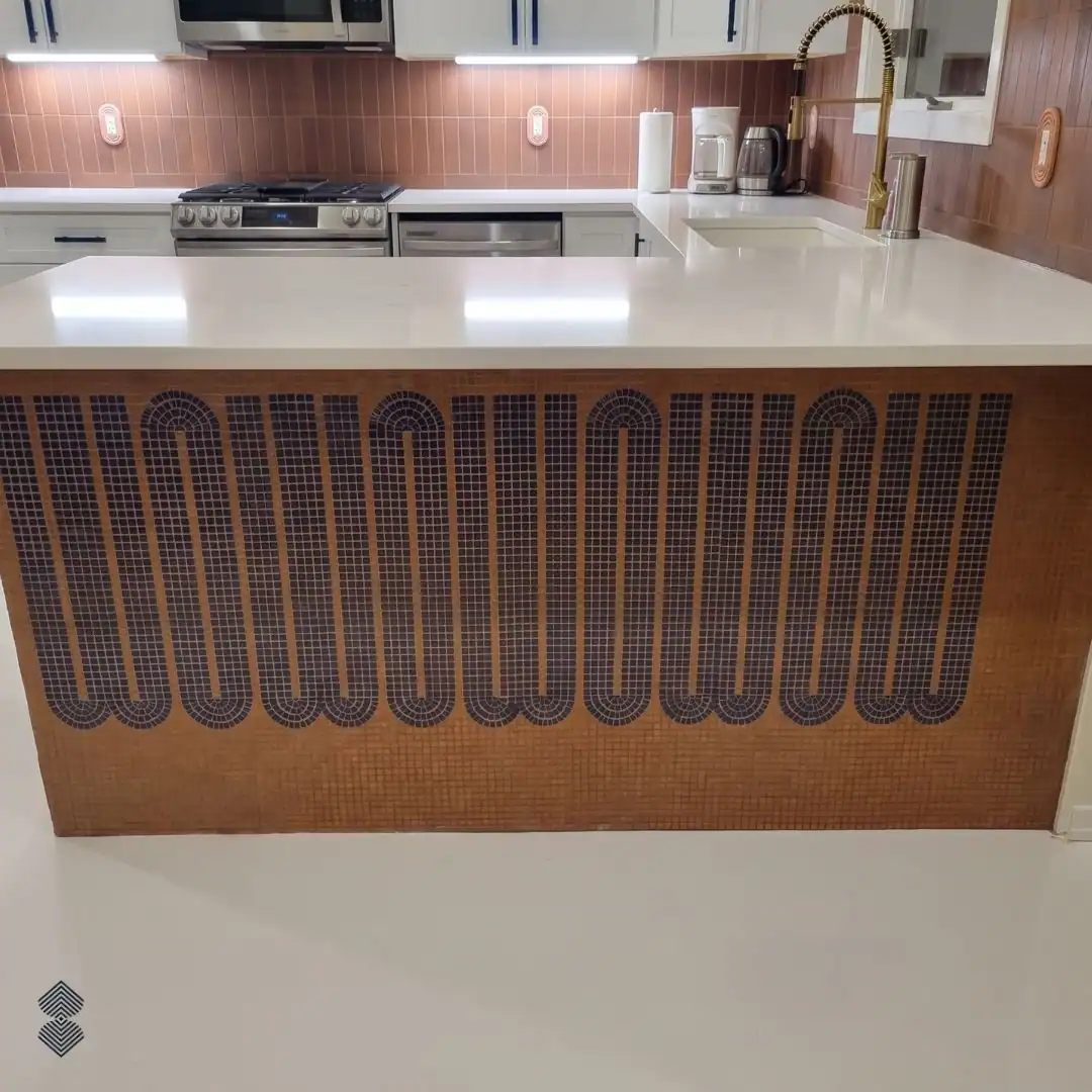 Amber Loop mosaic features deep plum geometric loops across a warm terracotta contemporary kitchen island front.