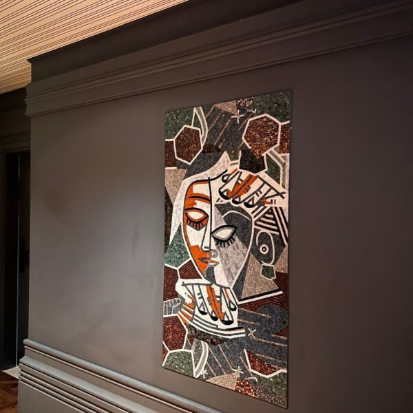 Cubist Portrait Face Mosaic Panel Cubist face mosaic art panel showing a fractured stone and glass portrait mounted on a dark restaurant wall