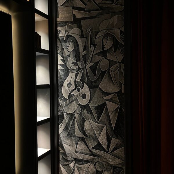 Cubist Musicians Wall Mosaic Panel A tall cubist figures wall mosaic showing two musicians in fractured gray and black stone tesserae, installed on a cafe wall.
