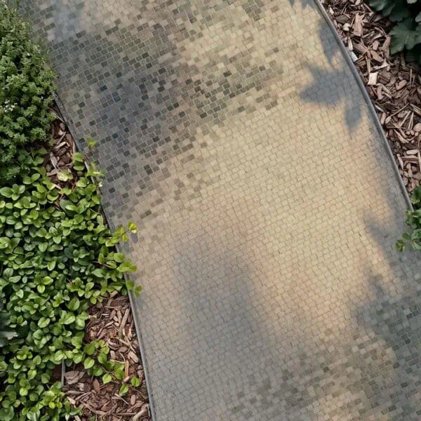 Curved Garden Mosaic Walkway Overhead view of a curved mosaic walkway tile path made of small square tesserae running between garden plantings.