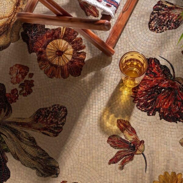 Floral Mosaic Walkway A floral mosaic walkway made of hand-cut stone tesserae showing layered amber and burgundy flowers set into a cream stone garden path.