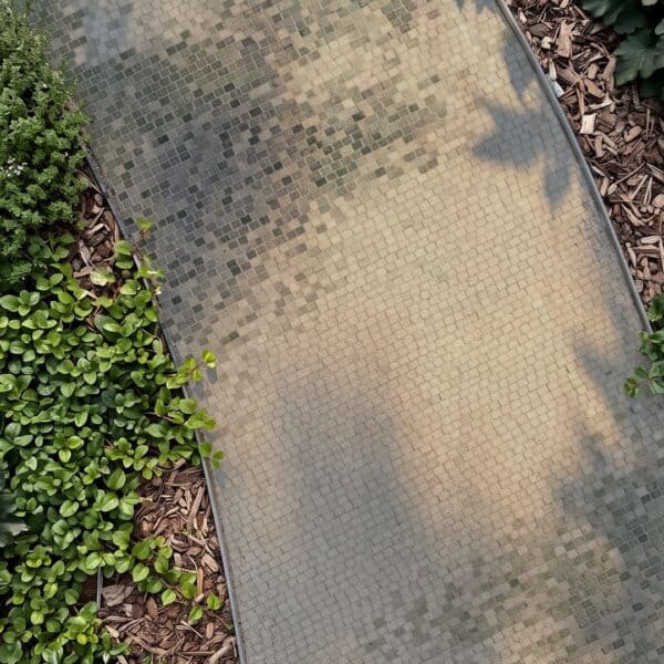 Mottled Stone Mosaic Garden Pathway Overhead view of a mosaic garden pathway made of small square tesserae in olive, sand, and gray tones curving between planting beds.