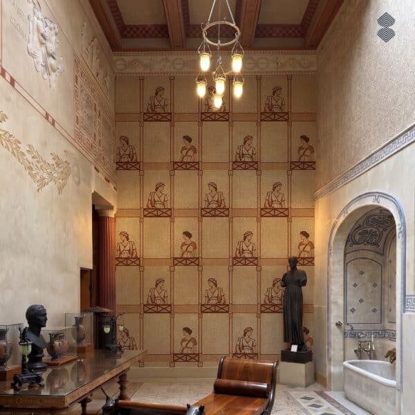 Roman Maiden Panel Grid Mosaic A roman maiden panel mosaic covering a wall in a grid of repeating terracotta and cream draped female figures