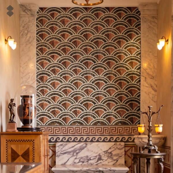 A roman scallop wall mosaic panel with layered fan tesserae in terracotta, charcoal and cream above a Greek key border