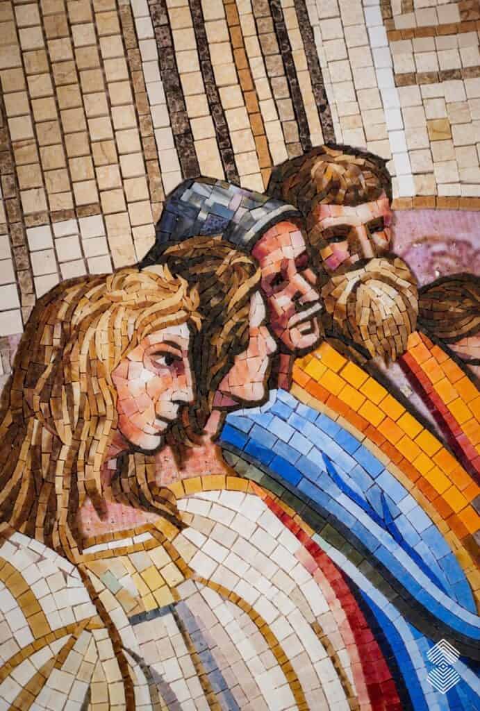 Detailed Renaissance mosaic wall art with ornamental borders, and classical figures.