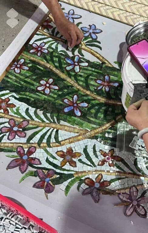 Traditional Mughal-inspired mosaic portrait featuring a woman seated among flowering trees.