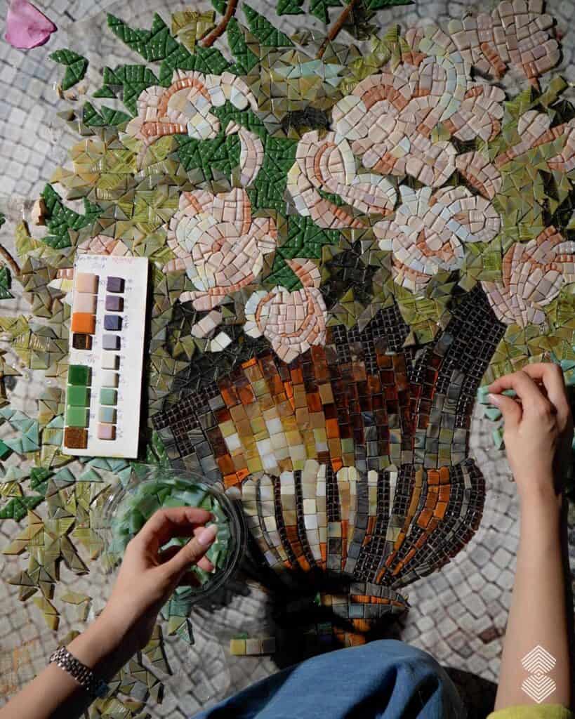 Mosaic artist design team selecting glass and marble colors for a custom mural