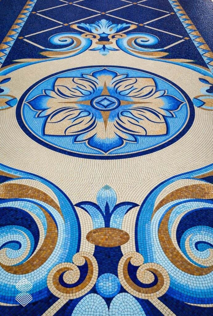 Close-up of Renaissance mosaic art highlighting ornate borders, rich background colors, and intricate hand-cut tile arrangements.