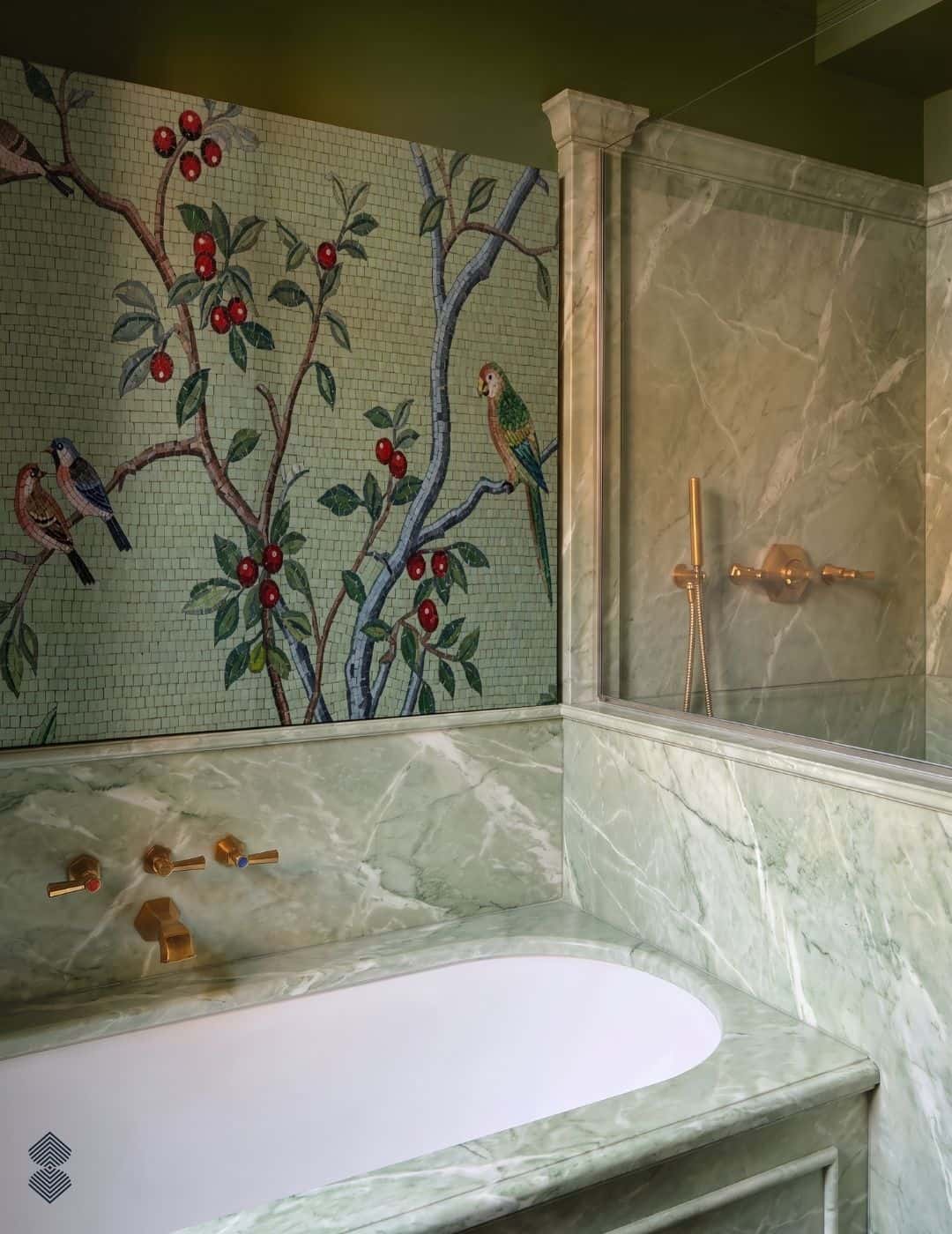 A bird blossom mosaic mural on a sage-green wall showing birds perched on flowering branches with red berries
