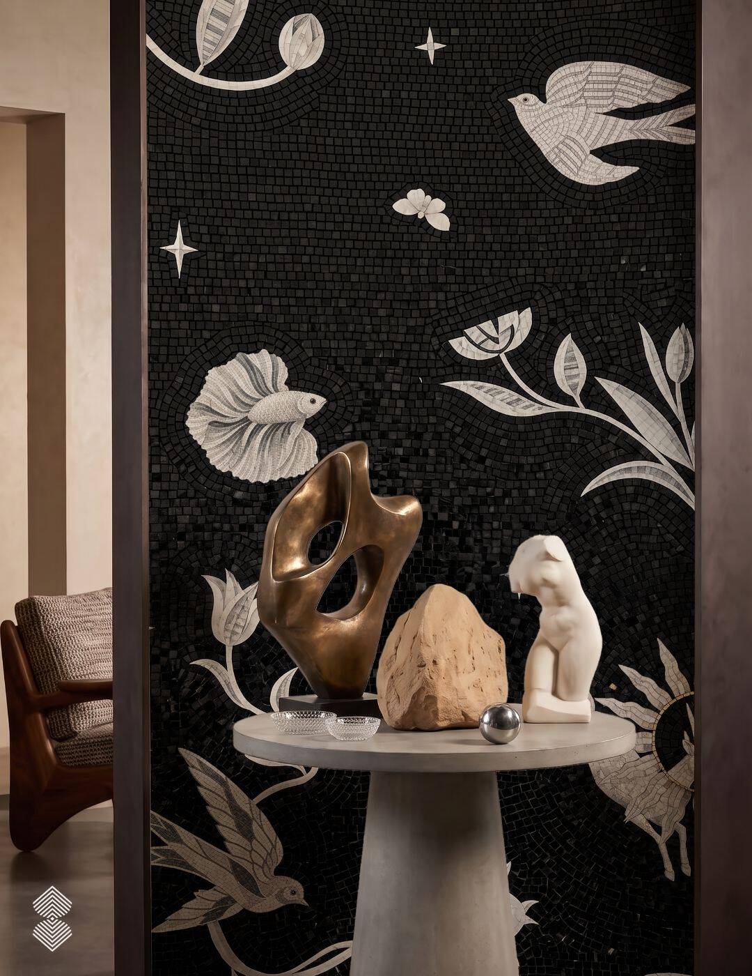 A tall black and white nature mosaic mural with birds, a fish and flowering stems in pale stone against a black ground