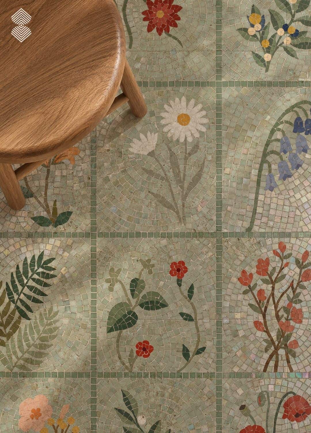 A grid of mosaic tile squares each depicting a different flower or fern on a pale green ground, installed in a shower niche.