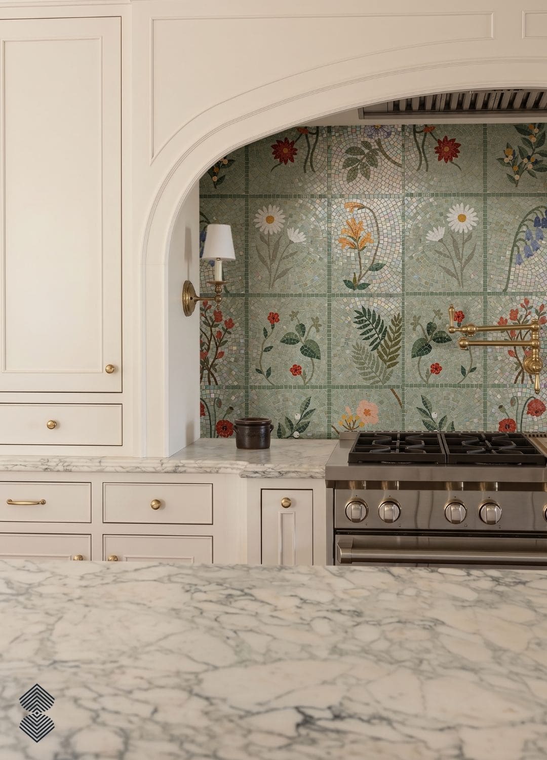 A grid of mosaic tile squares each depicting a different flower or fern on a pale green ground, installed in a shower niche.