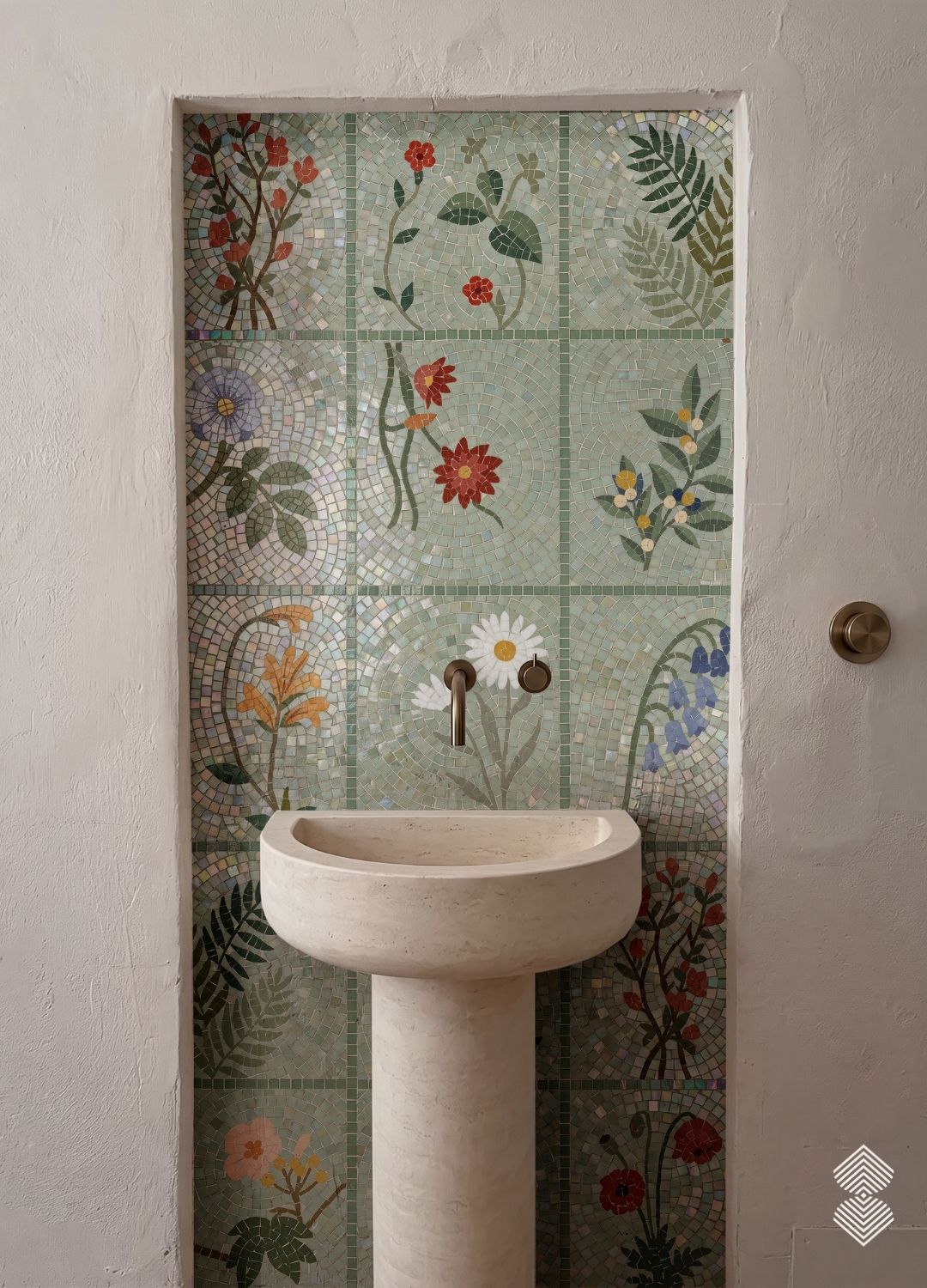 A grid of mosaic tile squares each depicting a different flower or fern on a pale green ground, installed in a shower niche.