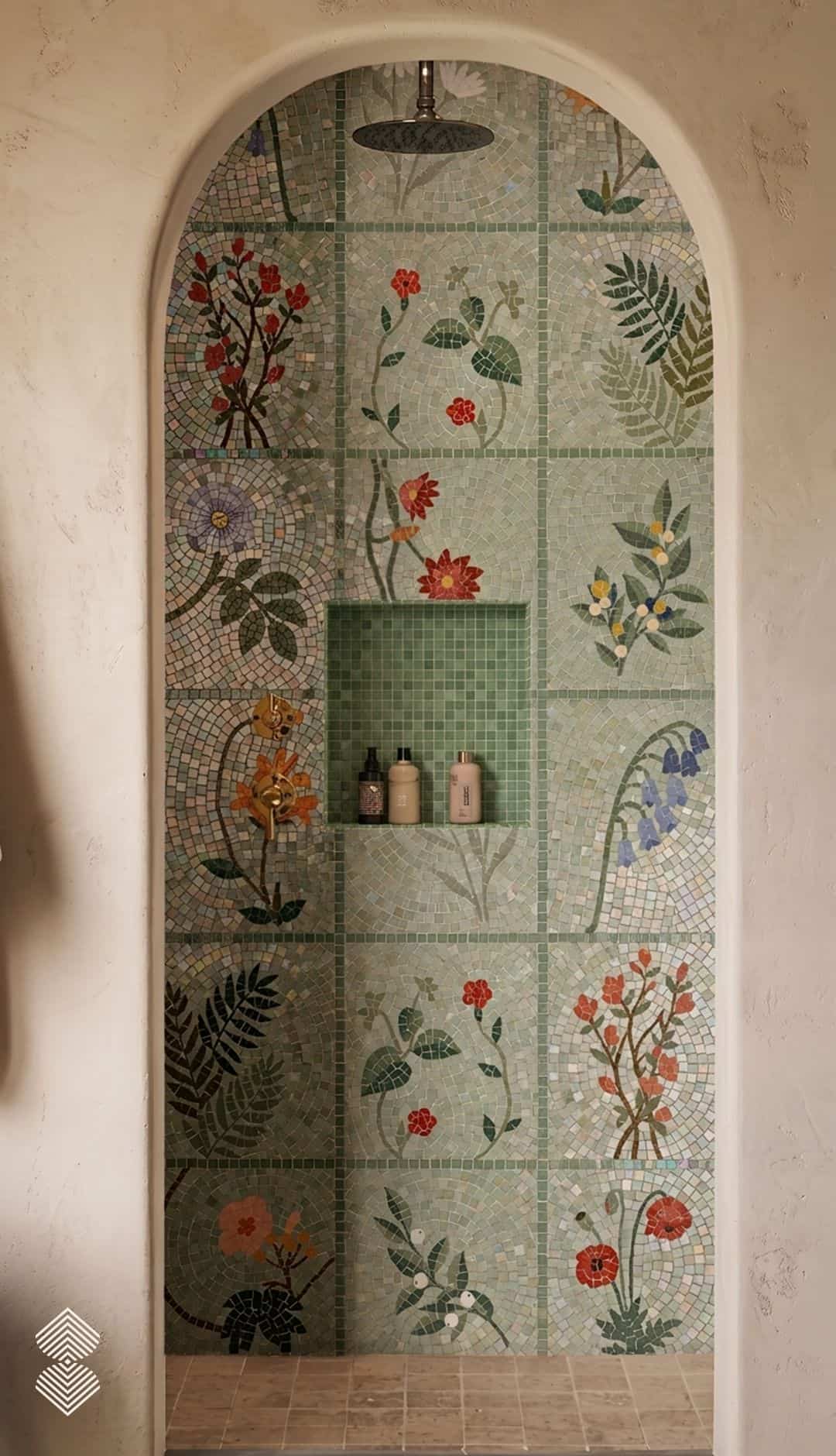 A grid of mosaic tile squares each depicting a different flower or fern on a pale green ground, installed in a shower niche.