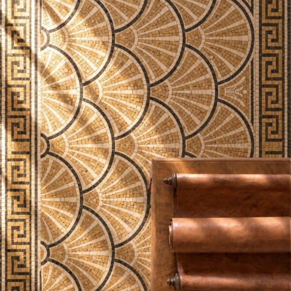A classical scallop floor mosaic with repeating fan-shell arcs in cream and gold stone framed by a Greek key border.
