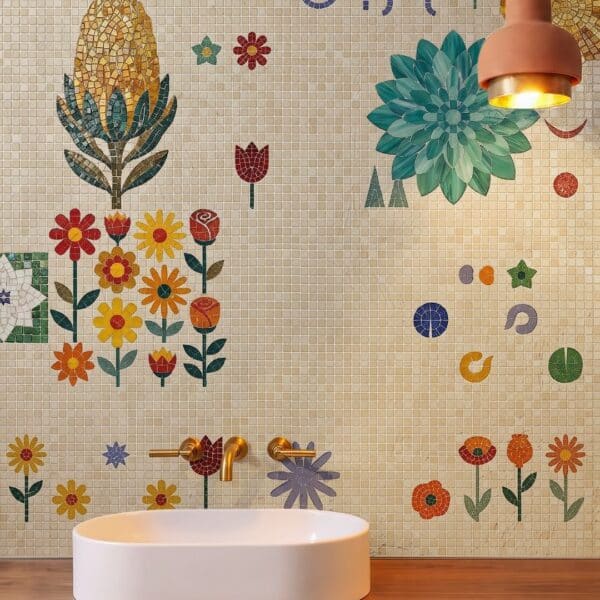 A bathroom wall covered in a folk flower wall mosaic of scattered daisies, tulips and a teal dahlia on a cream tile ground.