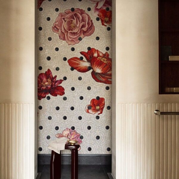 A tall alcove mosaic of red and pink roses scattered over a white ground with black polka dots.