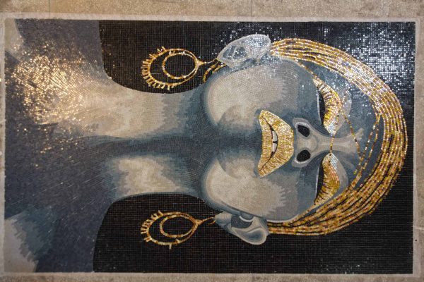 A beautiful lady's face portrayed through intricate mosaic artistry.