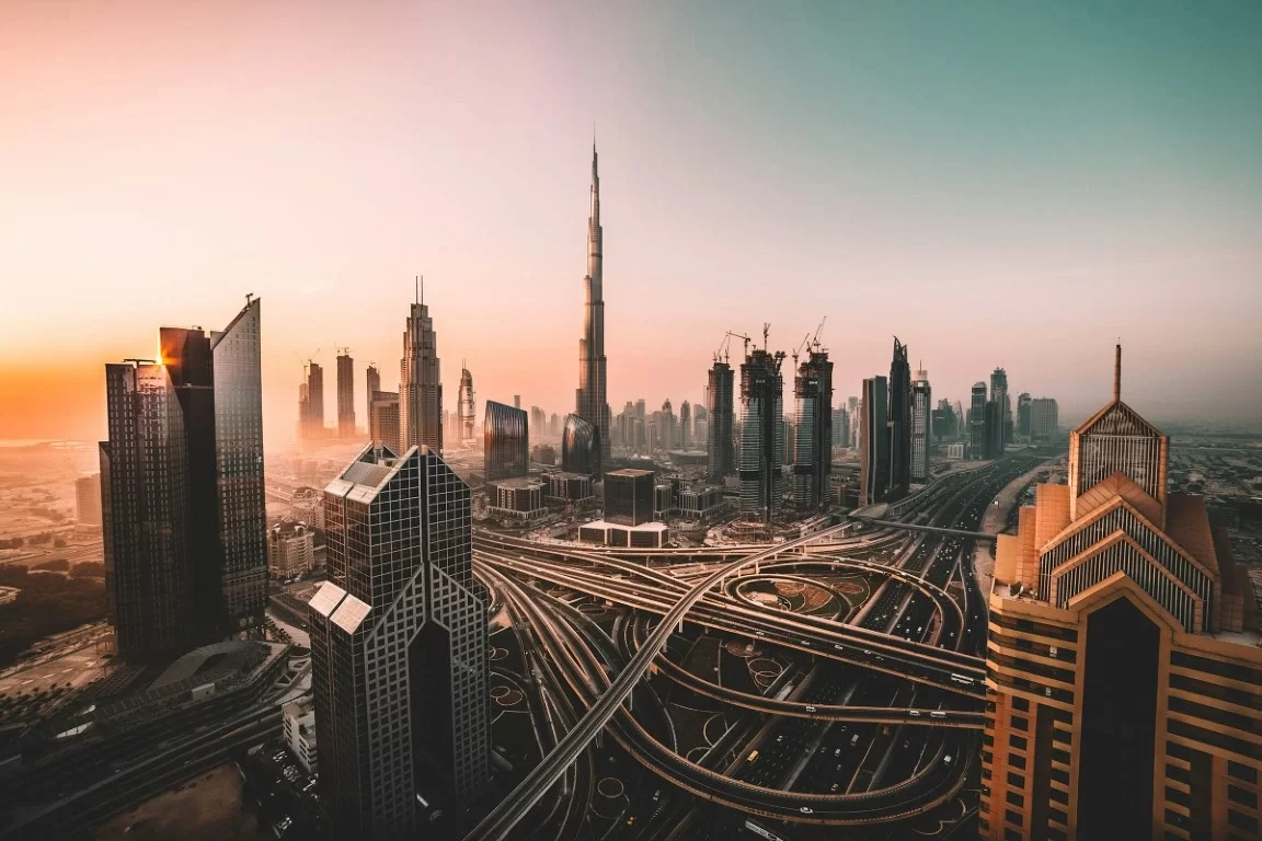 Dubai sunrise unveils architectural marvels, rising towers, and intricate highways woven through golden desert light.