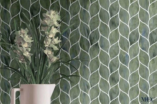Folha. Product image showing Jade Glass waterjet cut tiles from Lavande collection. Custom leaft shaped green tile design from MEC.