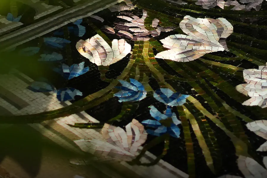 Hand-laid tile mosaic: delicate white and blue flowers, detailed leaves, artisan-made
