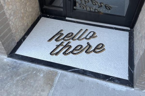 "Hello There" typography mural with a fish-scale tile background, featuring 24l Oro Gold leaf glass mosaic entrance