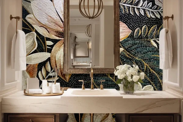 Bathroom wall mosaic mural with large floral patterns in soft ivory, blush, and gold tones against a dark background, made from glass mosaic tiles.