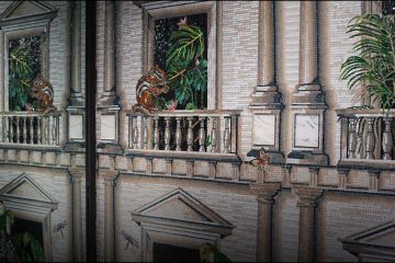Architectural mosaic mural depicting classical balconies with lush plants, monkeys, butterflies, and tropical wildlife details.