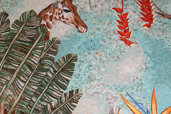 Colorful jungle mosaic featuring a giraffe, monkey, tropical leaves, and bright orange and yellow flowers.