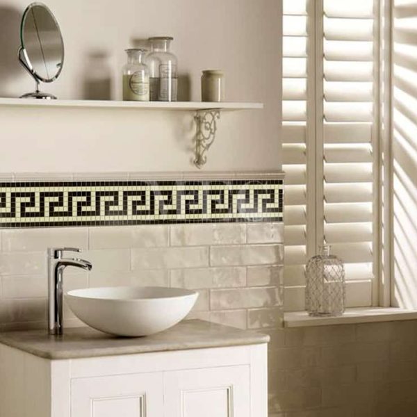 bathroom wall clad with mosaic borders tiles featuring a Greek Key pattern